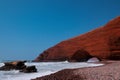 Remaining red sandstone stone arch in Legzira Beach. Rugged coastline in Tiznit Province of Morocco, Africa. Atlantic Ocean waves. Royalty Free Stock Photo