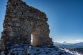 Remains of an ancient fortress on the snowy mountains Royalty Free Stock Photo