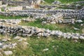 Remains of ancient walls on the site of a destroyed antique city Royalty Free Stock Photo