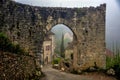 Remains of an arched stone gateway to a Medieval French village.