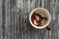 Remains of berries and herbs in empty teacup.