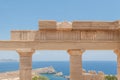 Remains of columns in the Greek Doric Order. Blue sky and blue sea. Greece