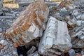 The remains of a concrete building. Part of the wall of red brick closeup lying in a pile of rubble