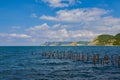 The remains of the destroyed old pier in the sea. Rusty piles stick out of the water. Russia, Krasnodar Krai, village of Big