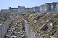 The remains of the destroyed tunnel on the background of a large ruined industrial building. Background, perspective