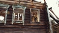 Remains of a destroyed wooden house with glassless windows.