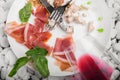 The remains of food on a plate with a knife and fork on a white stones background. Copy space. Royalty Free Stock Photo