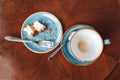 remains of food on the table in the cafe, flat view. Mug with coffee and fork with a plate with crumbs from a cheesecake Royalty Free Stock Photo