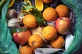 Food waste problem, leftovers Thrown into into the trash can. Spoiled food in refuse bin. Spoiled oranges and apples close up. Eco Royalty Free Stock Photo