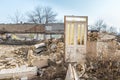 Remains of hurricane or earthquake aftermath disaster damage on ruined old houses with collapsed roof and wall