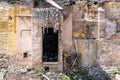 Remains of hurricane or earthquake aftermath disaster damage on ruined old houses with collapsed roof and wall