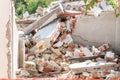 Remains of hurricane or earthquake disaster damage on ruined old house with collapsed roof and walls on the pile Royalty Free Stock Photo