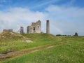 the remains of an old abandoned castle standing on a grassy hill with a rainbow Royalty Free Stock Photo