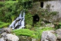 Remains of an old abandoned mill and water cascade with lush vegetation, Morigerati, Cilento, Campania, Italy