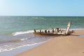 remains of old boat on shore. wooden longtail covered by sand. Travel landscape tropical sea beach