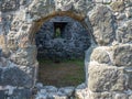 Remains of an old castle. Ancient fortifications made of stone. Museum in the open air. Medieval castle. Window in the wall