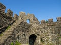 Remains of an old castle. Ancient fortifications made of stone. Museum in the open air. Medieval castle. Window in the wall