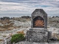 A remains of an old fireplace on the shore of the Pacific ocean at Kaikoura in New Zealand Royalty Free Stock Photo