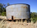 An old abandoned bullet ridden water tank in an old ghost town in the southwest