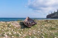 Remains of an old wooden fishing boat on the rocky shore of Lake Baikal. Olkhon Island