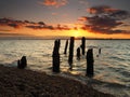 Remains of old wooden jetty looking to Harwich with stunning sunset, Felixstowe Royalty Free Stock Photo