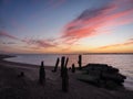 Remains of old wooden jetty looking to Harwich with stunning sunset, Felixstowe Royalty Free Stock Photo