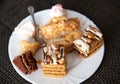 The remains of pastries and cake in a plate on the table. Harmful delicious sweet food. Close-up, finished