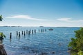 Remains of the pier and pillars in the ocean water Royalty Free Stock Photo