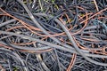 Remains of plastic electrical cables abandoned in a field by thieves Royalty Free Stock Photo