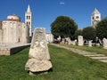 Remains of Roman forum with St Donat church and bell tower of St Anastasia cathedral on background in old town of Zadar Royalty Free Stock Photo