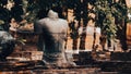 Remains of ruined Buddha figure in sitting poses at Ayutthaya Historical park, Thailand.