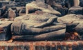 Remains of ruined Buddha figure in sitting poses at Ayutthaya Historical park, Thailand.