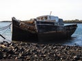 Remains ruins of an old historical capsized tilted fishing boat ship wreck at Greenpoint Ship Graveyard New Zealand