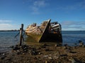 Remains ruins of an old historical capsized tilted fishing boat ship wreck at Greenpoint Ship Graveyard New Zealand