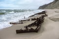 The remains of a seagoing vessel on the shore. Old Rusty Ship. The rusted wreckage of an old ship