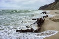 The remains of a ship on the sand, pieces of rusty iron on the seashore