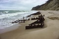 The remains of a ship on the sand, pieces of rusty iron on the seashore