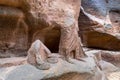 Remains of statues carved into the rock of canyon leading to Petra - the capital of the Nabatean kingdom in Wadi Musa city in Jord