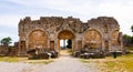Remains of stone city gate in ancient city of Perge in Turkey