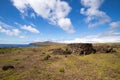 Remains of stone structures along the northern coast of Easter Island with the Poike volcano in the background, Easter Island, Royalty Free Stock Photo