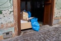 Remains of trash and garbage, plastic bags and cardboard boxes in the portal of a house in Toledo, Spain