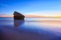 Remains of the watchtower on the shore of the beach at sunset