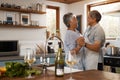 Remember how I wooed you with this move. a happy mature couple dancing together while cooking in the kitchen at home. Royalty Free Stock Photo