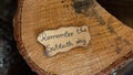 Remember the Sabbath Day text quote handwritten on old paper on an oak wooden log