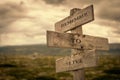 Remember to live message on wooden signpost outdoors in nature with dark moody feeling Royalty Free Stock Photo