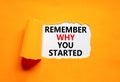 Remember why you started symbol. Concept word Remember why you started on beautiful white paper. Beautiful orange paper background