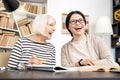 Joyful woman tutoring to senior woman