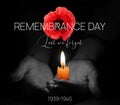 Remembrance Day Banner Template. Red Poppy over Burning Candle in the Human Hands. Royalty Free Stock Photo