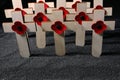 Remembrance Day poppy symbol on wooden cross. 11th November is a memorial day of the First World War. Royalty Free Stock Photo