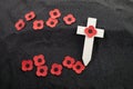 Remembrance Day poppy symbol on wooden cross. 11th November is a memorial day of the First World War. Royalty Free Stock Photo